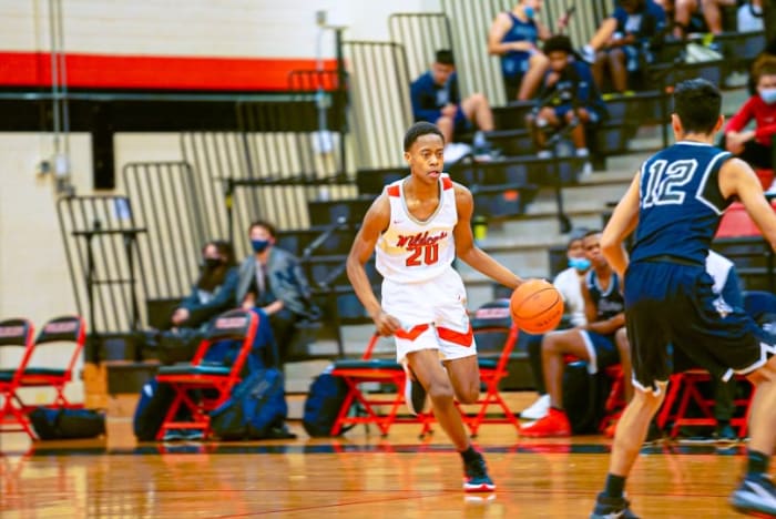 Tre Johnson dribbles the basketball